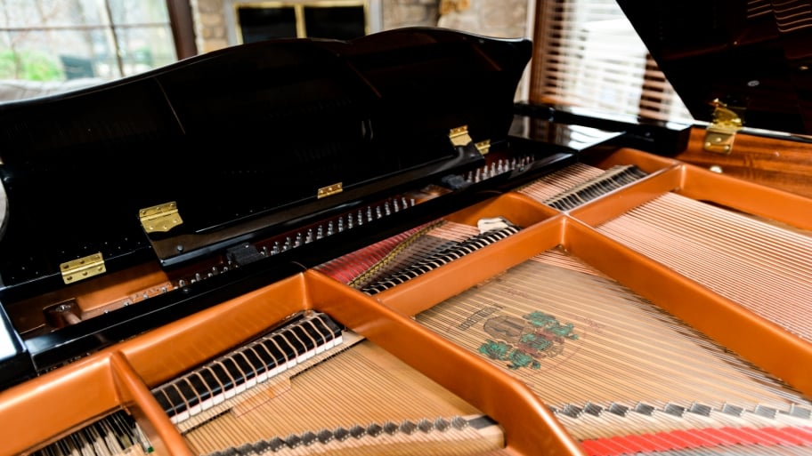 the inner workings of a baby grand piano